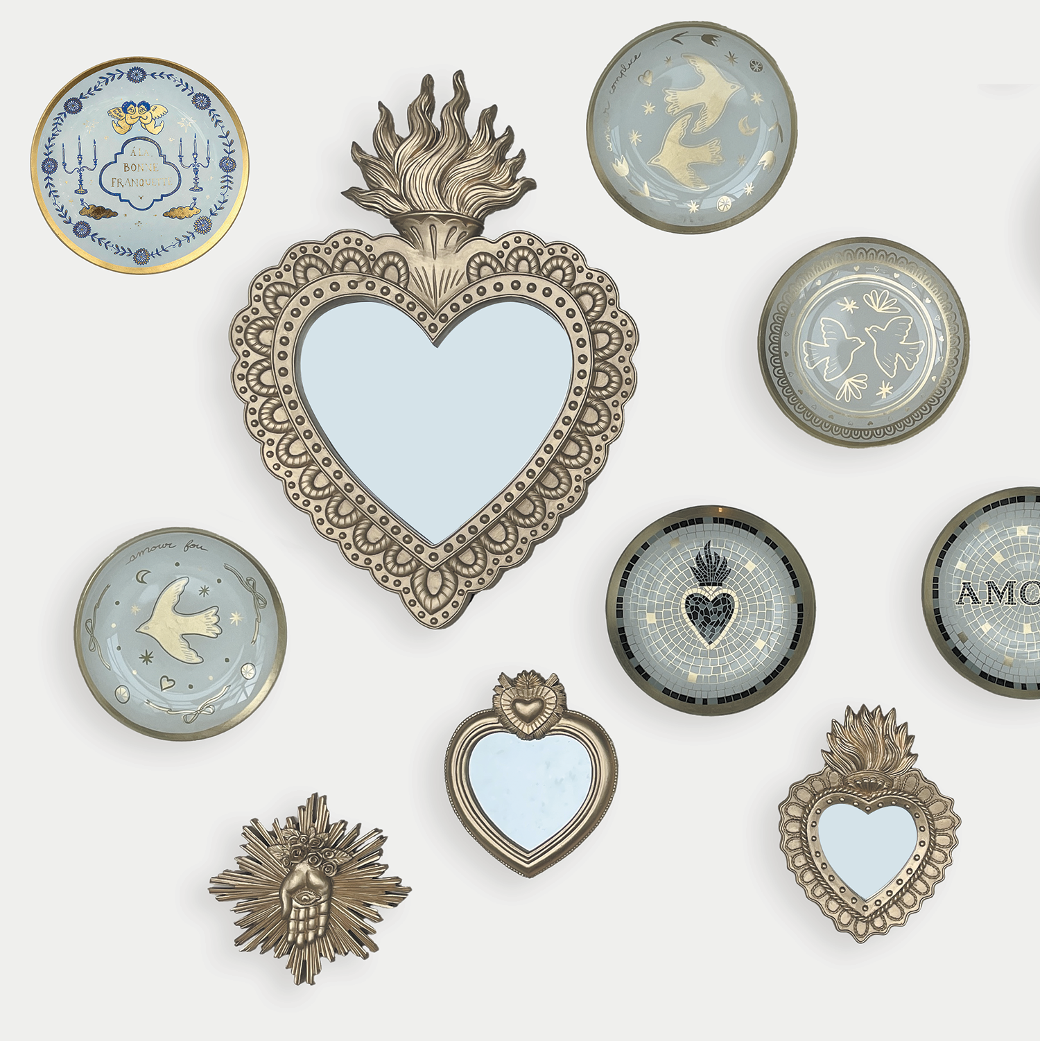 Collection of decorative heart-shaped mirrors and frames on a white background