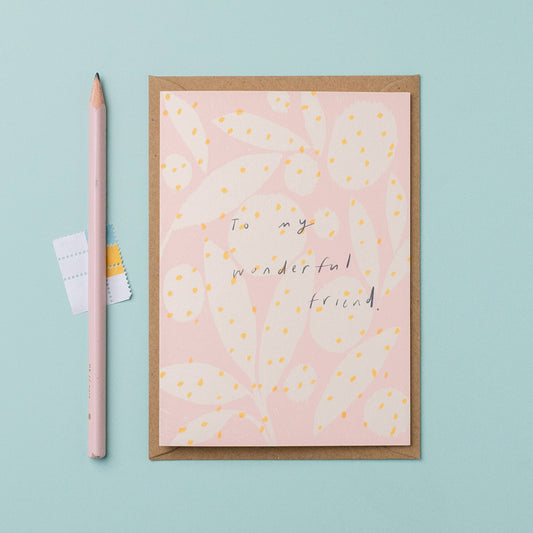 Greeting card with 'To my wonderful friend' text on a pink background, accompanied by a pink pencil and eraser on a light blue background.