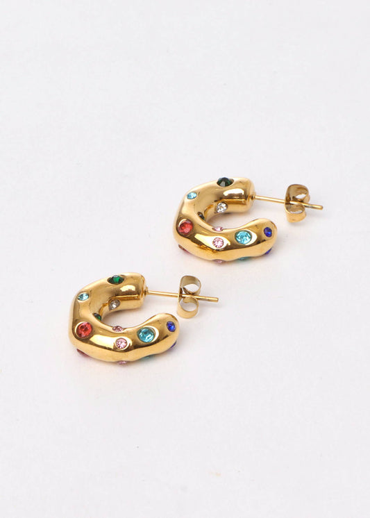 Gold hoop earrings with colorful gemstones on a white background