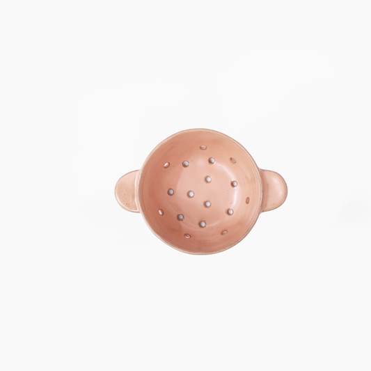 A small round colander with side handles, shown from a top-down view on a plain white background.
