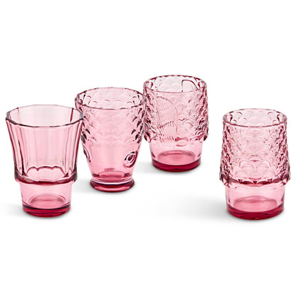 Set of four pink glass tumblers with textured fish design on a white background