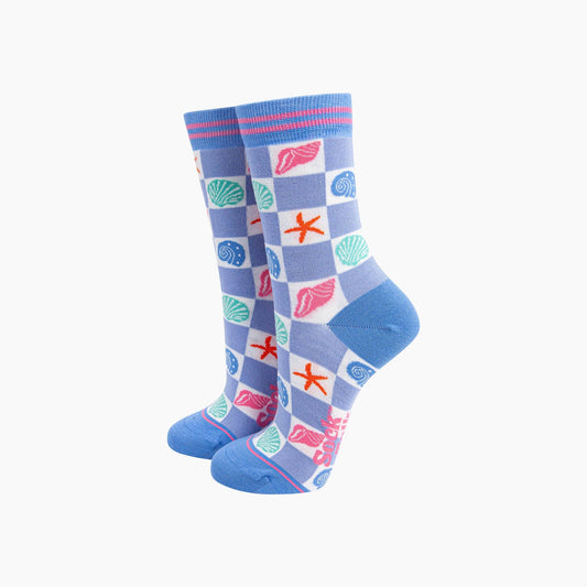 Pair of blue socks with shell and starfish pattern on a white background