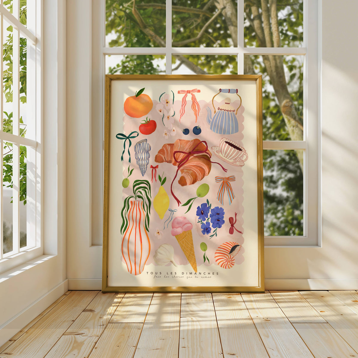 Framed artwork with colorful illustrations of everyday objects in a bright room with large windows.