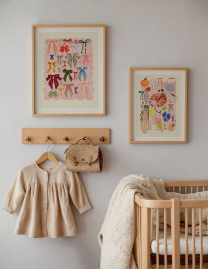 Nursery room with framed artwork, baby clothes, and crib.