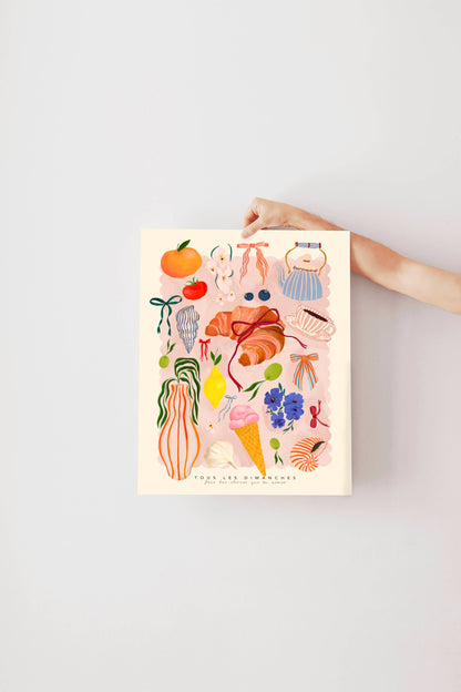 Hand holding a colorful illustration poster against a light gray background