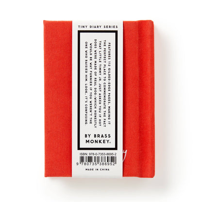 Red notebook with a white label on a white background
