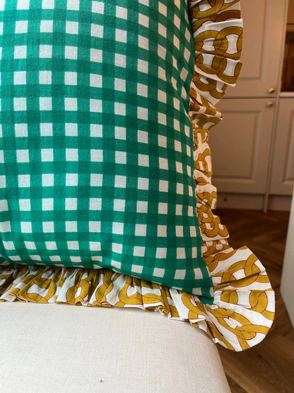 Close up on Turquoise green gingham cushion with chain frill pattern on a stool