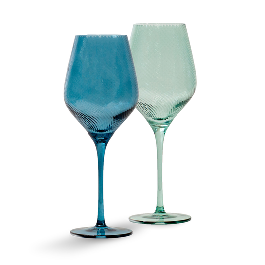 Two wine glasses, one blue and one green, on a white background
