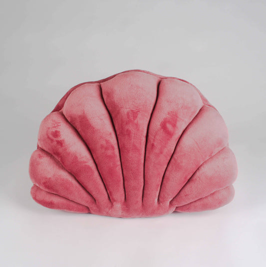 Pink shell-shaped pillow on a light gray background