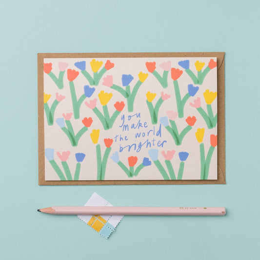 Greeting card with colorful floral design and text on a light blue background