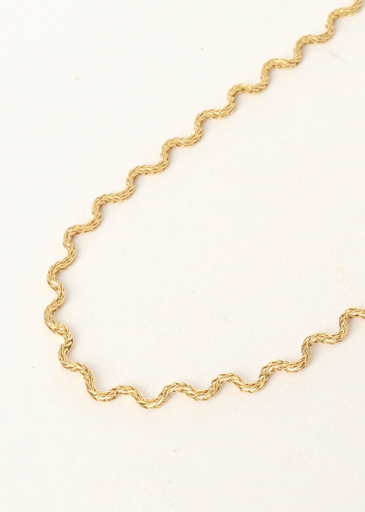 Gold chain necklace on a white background
