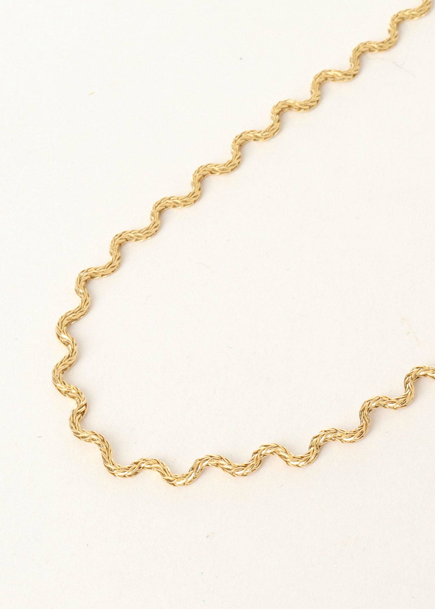 Gold chain necklace on a white background