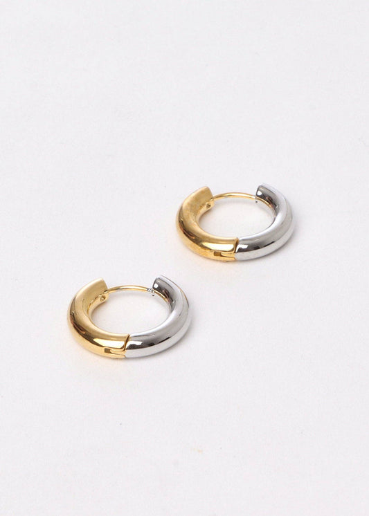 Two gold and silver hoop earrings on a white background