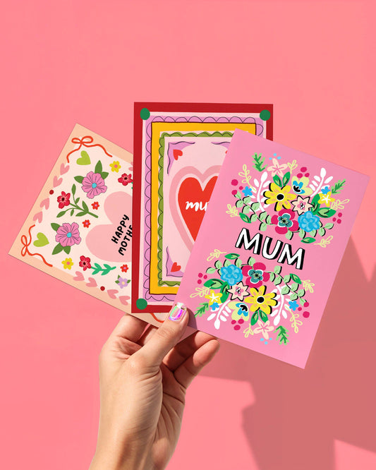 Three colorful greeting cards with floral designs and text on a pink background.