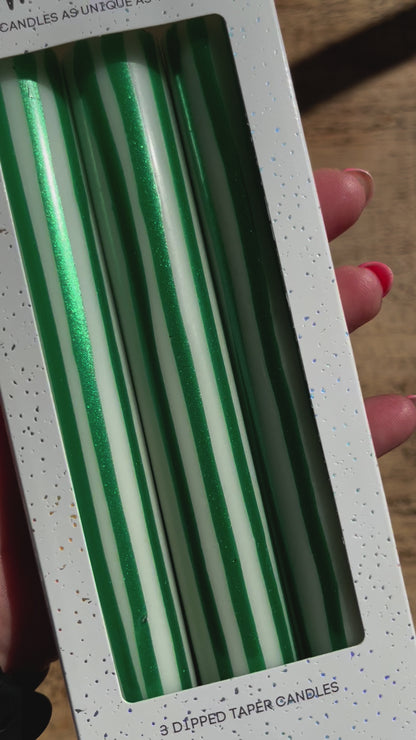 Green and white vertical striped candles