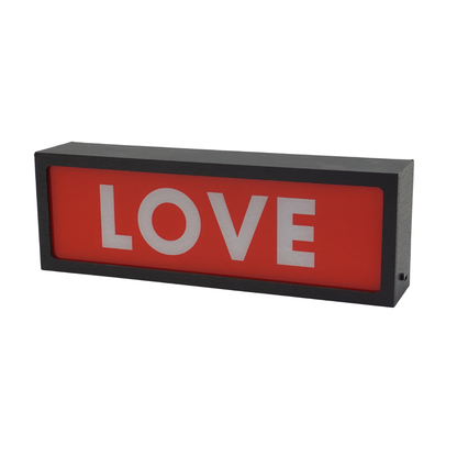 Rectangular red sign with 'LOVE' in white on a white background